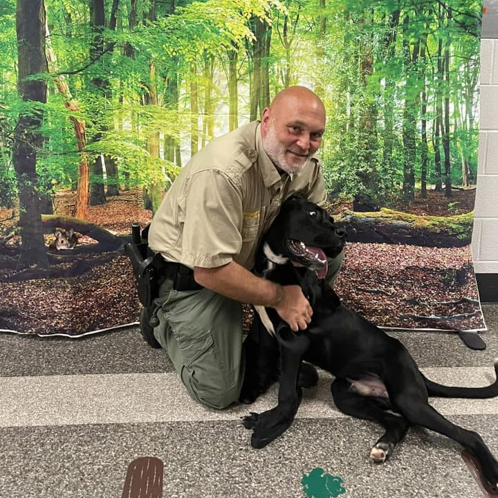 Field deputy Chris with black dog